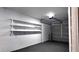 Garage with overhead door and shelving for storage at 27254 Roper Rd, Brooksville, FL 34602