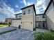 Two-story townhome with two-car garage and landscaped front yard at 29850 Southwell Ln, Wesley Chapel, FL 33543