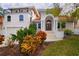Two-story house with a balcony and lush landscaping at 301 Midway Is, Clearwater Beach, FL 33767