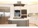 Modern kitchen with stainless steel appliances and granite countertops at 301 Midway Is, Clearwater Beach, FL 33767