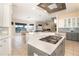 Open concept kitchen features gas range and island overlooking living area at 301 Midway Is, Clearwater Beach, FL 33767