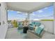 Relaxing covered patio features comfortable seating, perfect for enjoying scenic views and outdoor living at 3027 Bermuda Sloop Cir, Ruskin, FL 33570