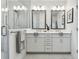 Elegant bathroom featuring dual sinks, quartz counters, and a glass shower enclosure at 3027 Bermuda Sloop Cir, Ruskin, FL 33570