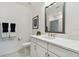 Modern bathroom with white marble countertops, white cabinets, and a large mirror at 3027 Bermuda Sloop Cir, Ruskin, FL 33570