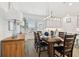 Dining room showcasing wood table with seating, modern light fixture, and neutral decor at 3027 Bermuda Sloop Cir, Ruskin, FL 33570