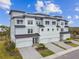 Beautiful townhomes showcase a blend of modern design and comfortable living, enhanced by lush landscaping and clear skies at 3027 Bermuda Sloop Cir, Ruskin, FL 33570