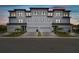 Contemporary townhome showcasing a clean facade with a private garage and neatly landscaped front yard at 3027 Bermuda Sloop Cir, Ruskin, FL 33570