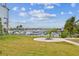Manicured lawn with marina and dock in the background on a sunny day at 3027 Bermuda Sloop Cir, Ruskin, FL 33570