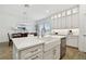 Open-concept kitchen featuring a large island, white cabinets, and modern appliances at 3027 Bermuda Sloop Cir, Ruskin, FL 33570