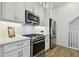 Modern kitchen with stainless steel appliances and white cabinets at 3027 Bermuda Sloop Cir, Ruskin, FL 33570