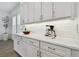Bright kitchen featuring white cabinets and countertops, with subway tile backsplash at 3027 Bermuda Sloop Cir, Ruskin, FL 33570