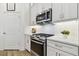 Modern kitchen featuring stainless steel appliances and white cabinetry at 3027 Bermuda Sloop Cir, Ruskin, FL 33570