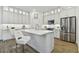 Modern kitchen featuring white cabinets, an island with seating, and stainless steel appliances at 3027 Bermuda Sloop Cir, Ruskin, FL 33570