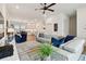 Spacious living room features a large gray couch, blue accent chair, and stylish decor at 3027 Bermuda Sloop Cir, Ruskin, FL 33570