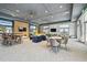 Bright lounge area with modern seating, tables, and televisions for entertainment and relaxation at 3027 Bermuda Sloop Cir, Ruskin, FL 33570