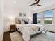 Well-lit main bedroom features a king bed, ceiling fan, and waterfront views at 3027 Bermuda Sloop Cir, Ruskin, FL 33570