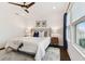 Well-lit main bedroom features a king bed, ceiling fan, and natural light at 3027 Bermuda Sloop Cir, Ruskin, FL 33570