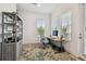 Bright home office featuring modern desk, stylish shelving, and natural light at 3027 Bermuda Sloop Cir, Ruskin, FL 33570