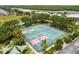 Aerial view of tennis courts, perfect for active residents to enjoy a match in a lush tropical setting at 3027 Bermuda Sloop Cir, Ruskin, FL 33570