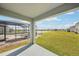 Covered patio overlooks a spacious backyard with a pool and lake views at 31814 Oyster Trellis Ln, Wesley Chapel, FL 33545