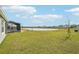 View of backyard with lake and surrounding houses at 31814 Oyster Trellis Ln, Wesley Chapel, FL 33545