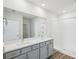 Bathroom boasts double vanity, large mirror, and a shower at 31814 Oyster Trellis Ln, Wesley Chapel, FL 33545