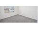 Bright bedroom with grey carpet, window, and ample space at 31814 Oyster Trellis Ln, Wesley Chapel, FL 33545