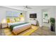 Bright bedroom with a yellow and green color scheme and hardwood floors at 31814 Oyster Trellis Ln, Wesley Chapel, FL 33545