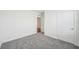 Spacious bedroom with grey carpet and an open doorway at 31814 Oyster Trellis Ln, Wesley Chapel, FL 33545