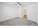 Bright bedroom with grey carpet and an open doorway at 31814 Oyster Trellis Ln, Wesley Chapel, FL 33545