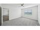 Bright bedroom with ceiling fan, carpet, and access to another room at 31814 Oyster Trellis Ln, Wesley Chapel, FL 33545