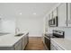 Modern kitchen with stainless steel appliances and an island at 31814 Oyster Trellis Ln, Wesley Chapel, FL 33545