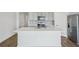 Modern kitchen with stainless steel appliances and an island at 31814 Oyster Trellis Ln, Wesley Chapel, FL 33545