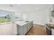 Modern kitchen with island, stainless steel appliances and backyard view at 31814 Oyster Trellis Ln, Wesley Chapel, FL 33545