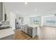 Modern kitchen with gray cabinets, an island, and a view to the backyard at 31814 Oyster Trellis Ln, Wesley Chapel, FL 33545