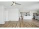 Open living room with wood-like floors and kitchen access at 31814 Oyster Trellis Ln, Wesley Chapel, FL 33545