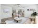 Open living room featuring a neutral color palette, stylish furniture, and a view into the kitchen at 31814 Oyster Trellis Ln, Wesley Chapel, FL 33545