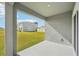 Screened patio with view of grassy backyard and other homes at 31814 Oyster Trellis Ln, Wesley Chapel, FL 33545