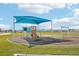 Community playground with shade structure, slides, and swings at 31814 Oyster Trellis Ln, Wesley Chapel, FL 33545