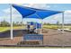 Community playground with shade structure and bench at 31814 Oyster Trellis Ln, Wesley Chapel, FL 33545