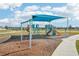Community playground with shade structure, slides, and swings at 31814 Oyster Trellis Ln, Wesley Chapel, FL 33545
