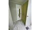 Small bathroom with a mirror and green cabinets at 34212 Canal N Dr # B, Pinellas Park, FL 33781