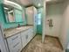 Bathroom with white cabinets, granite countertop and tile flooring at 34212 Canal N Dr # B, Pinellas Park, FL 33781