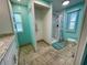 Bathroom with shower and toilet, teal walls, and tile floor at 34212 Canal N Dr # B, Pinellas Park, FL 33781