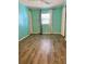 Bedroom featuring light wood-look flooring and teal walls at 34212 Canal N Dr # B, Pinellas Park, FL 33781
