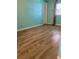 Bright bedroom with wood-look flooring and teal walls at 34212 Canal N Dr # B, Pinellas Park, FL 33781