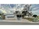 White manufactured home with covered patio and walkway, surrounded by trees at 34212 Canal N Dr # B, Pinellas Park, FL 33781