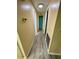 Long hallway with wood-look floors and neutral walls at 34212 Canal N Dr # B, Pinellas Park, FL 33781