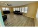 Spacious living room with gray vinyl flooring and two black leather couches at 34212 Canal N Dr # B, Pinellas Park, FL 33781