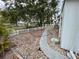 Landscaped side yard with gravel pathway and white vinyl fence at 34212 Canal N Dr # B, Pinellas Park, FL 33781
